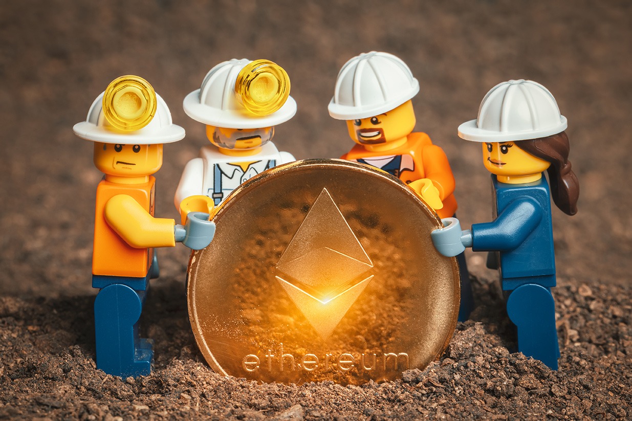A group of construction workers holding an ethereum coin, embracing the world of crypto.