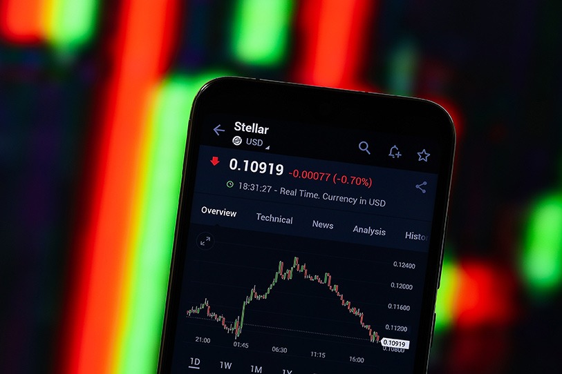 A smartphone is displaying a cryptocurrency market on the screen.