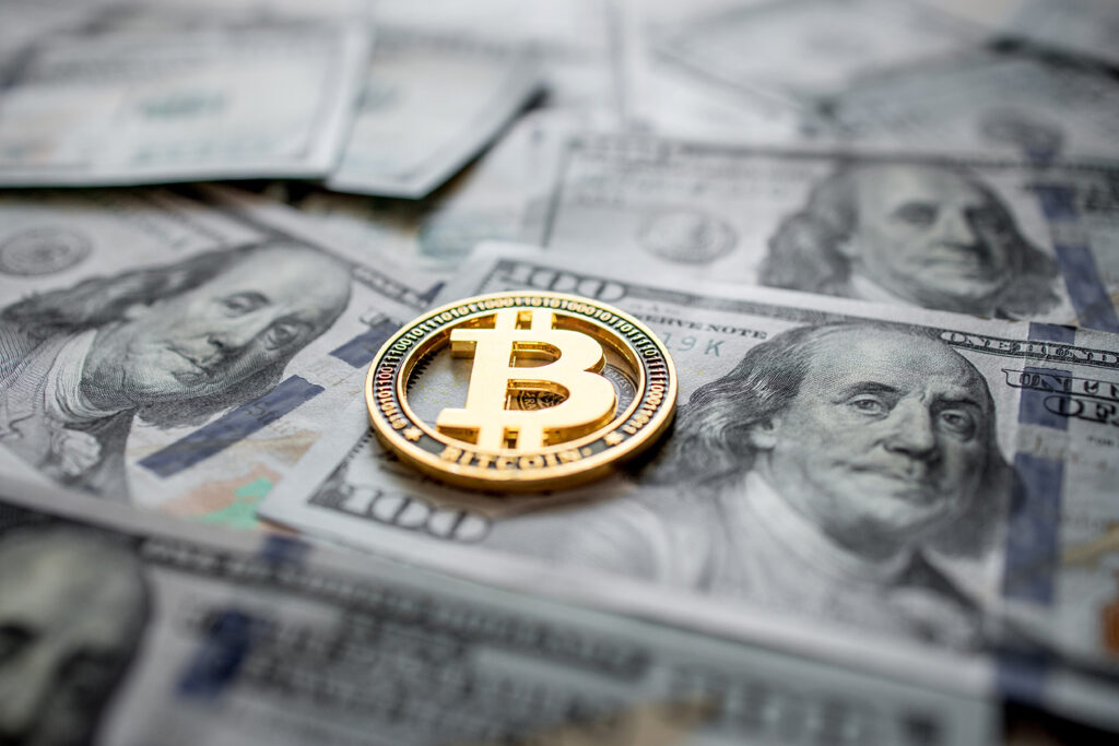 Bitcoin on a dollar background.