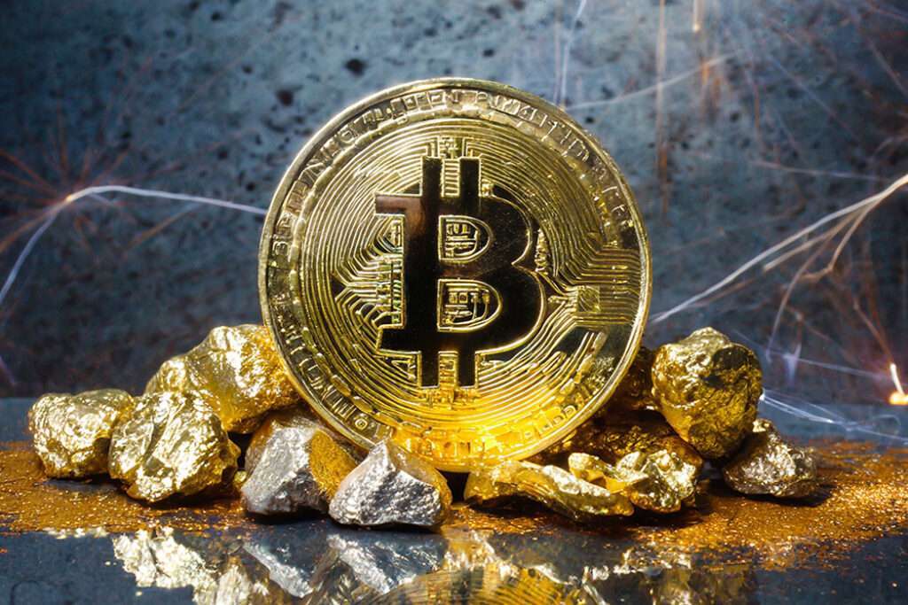 Bitcoin coin and mound of gold nuggets